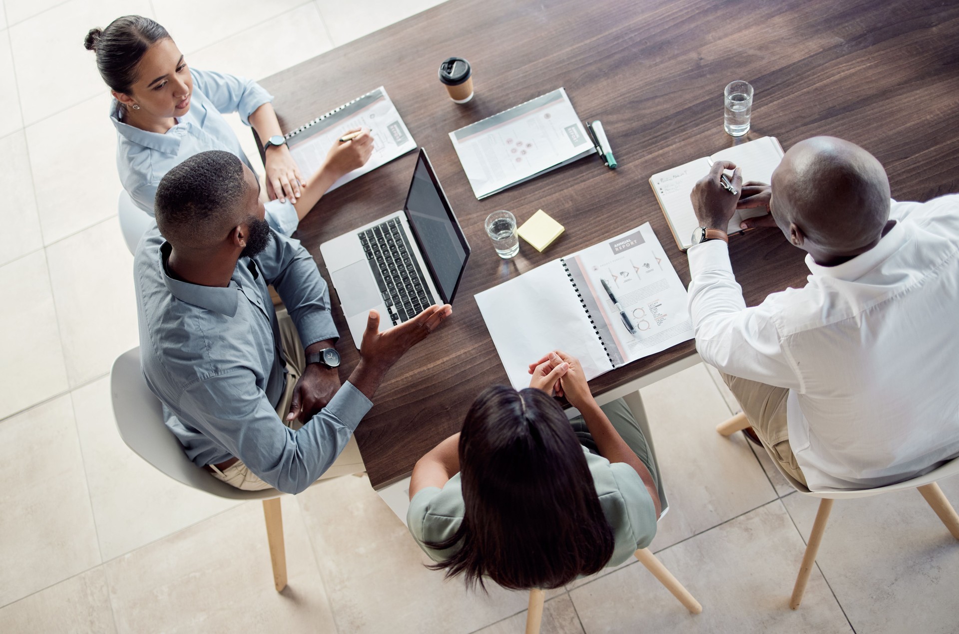 Business people in finance meeting with laptop, document report and notebook for company financial profit, strategy planning and marketing goal. Teamwork discussion and group manager KPI feedback